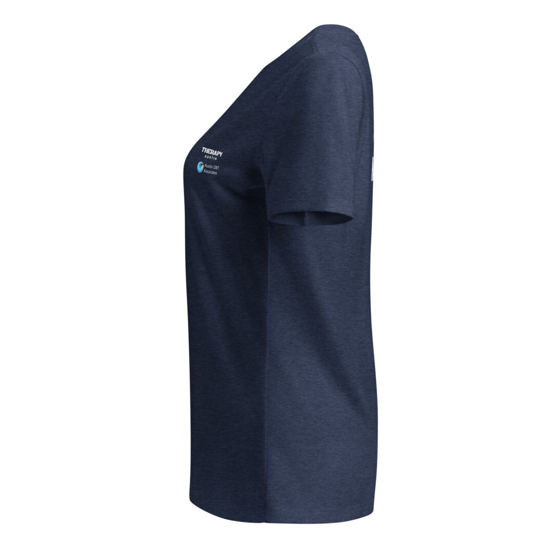A detailed side view of a navy heather v-neck t-shirt, highlighting the sleeve branding for Therapy Austin and Austin DBT Associates.