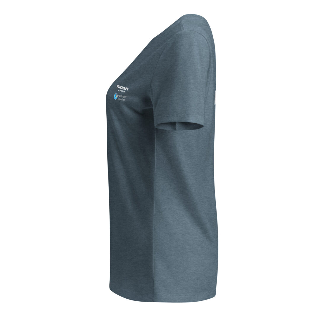 Side view of a slate blue v-neck t-shirt, showing the Therapy Austin and Austin DBT Associates logos printed on the sleeve.
